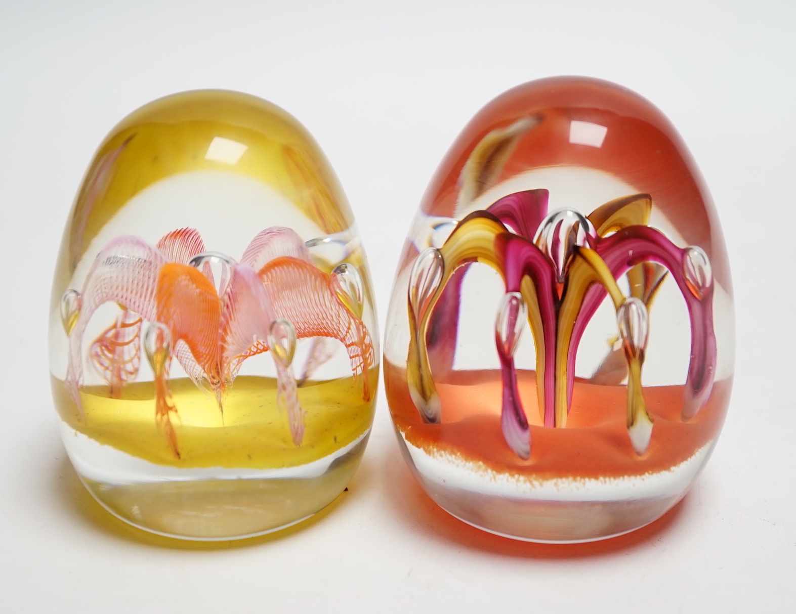 Two Paul Ysart ‘fountain’ glass paperweights, Harland/Highland period, one with Highland paperweights label, 7.5 and 7.7cm